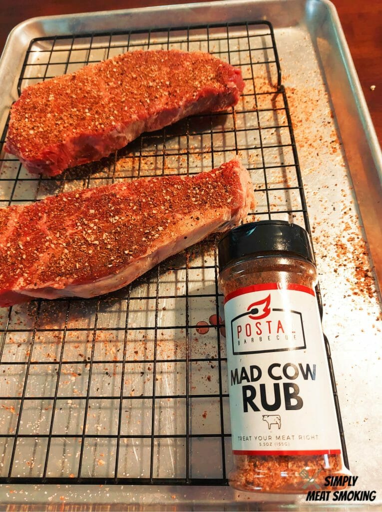 adding-rub-to-ny-strip-steaks