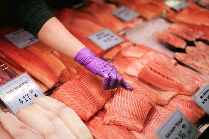 Picking out Fresh Salmon at The Market