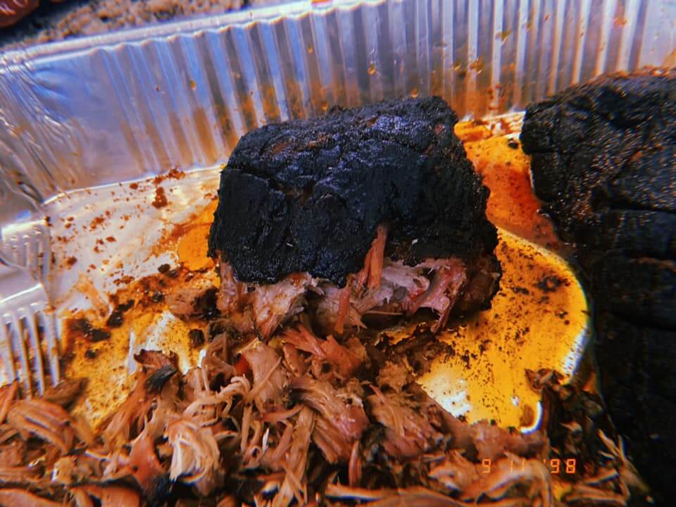 pork butt being pulled for barbecue pulled pork sandwich toasted sandwich